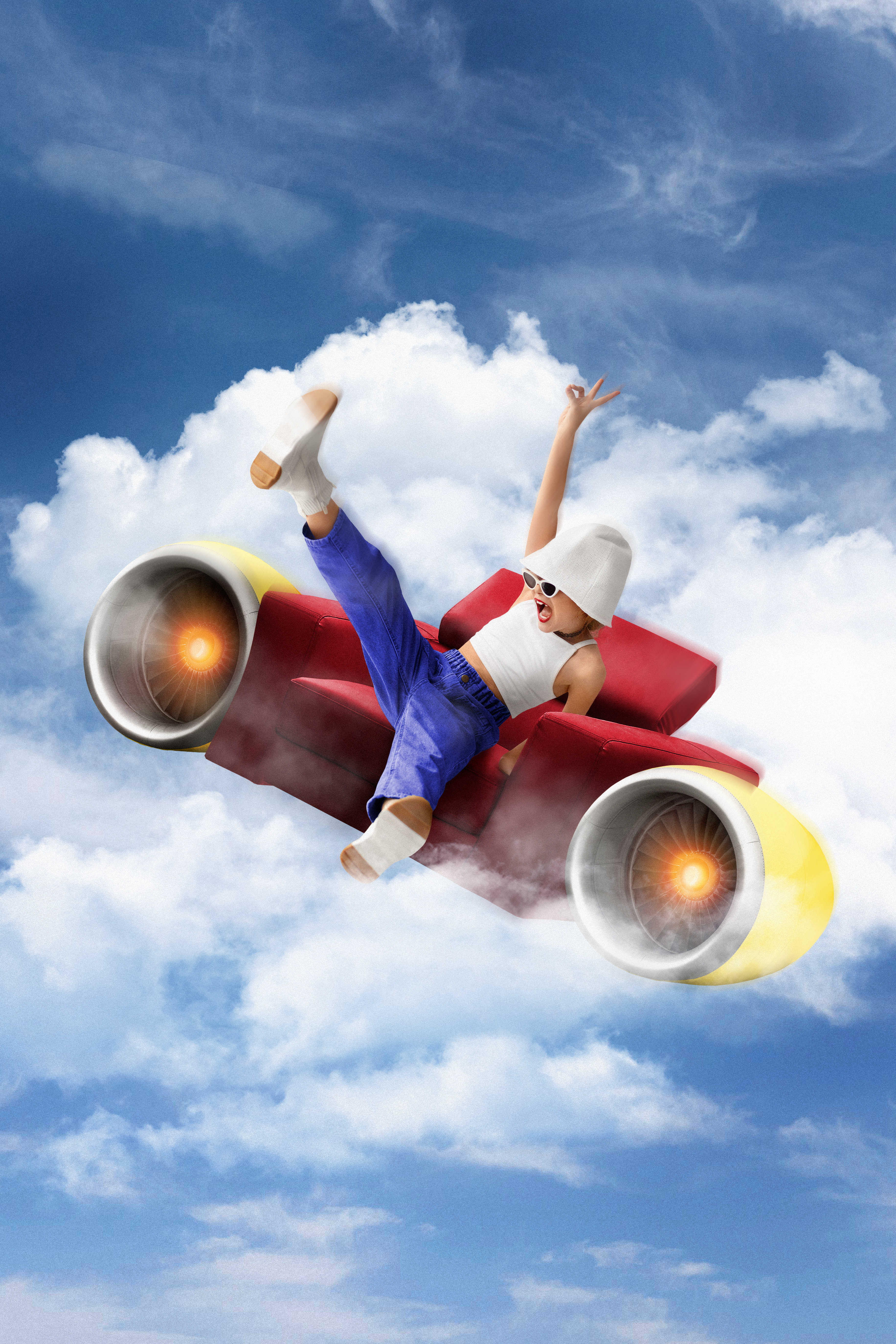 A happy child sitting at a desk and drawing in a journal with crayons.